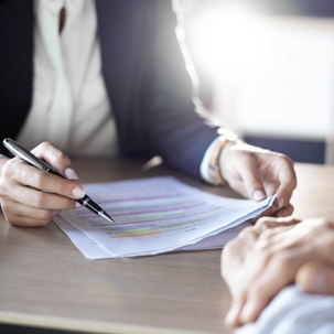 hands from a person reviewing a document they are holding